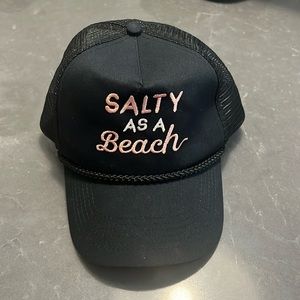 black hat with pink and white “salty as a beach” writing